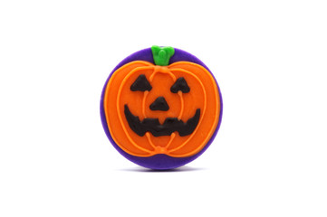 Cute Halloween Orange pumpkin chocolate cookie treat isolated on white background. Homemade biscuit for holiday festival. Treats for party.