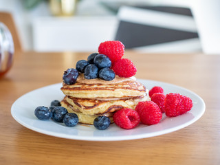 pencakes with peanut butter and fresh blueberries and raspberries