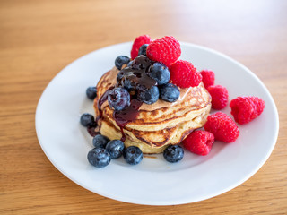 pencakes with peanut butter and fresh blueberries and raspberries