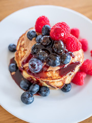 pencakes with peanut butter and fresh blueberries and raspberries