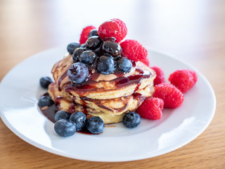 pencakes with peanut butter and fresh blueberries and raspberries