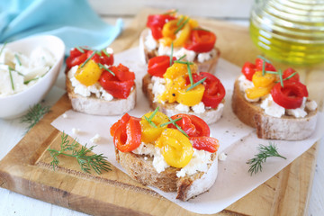 Appetizer. Slice of bread, cottage cheese and multi-colored grilled bell pepper with olive oil
