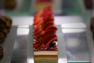 Cake shop with sweets on showcase table, close-up. 