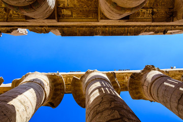 Columns in the great hypostyle hall of the Karnak temple. Looking up