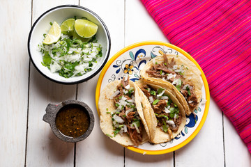Mexican slow cooked lamb tacos also called barbacoa on white background
