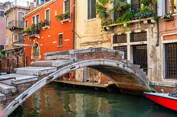 Fototapeta na wymiar Venice, Italy. Small private bridge over the channel on background of old houses