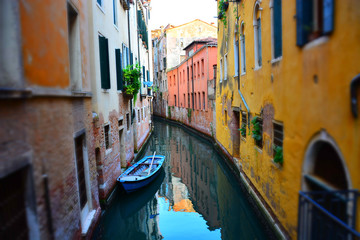 Empty Venetian boat on traditional narrow canal street, Venice, Italy