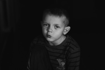 A funny and interesting expression on the face of a little boy showing indifference.