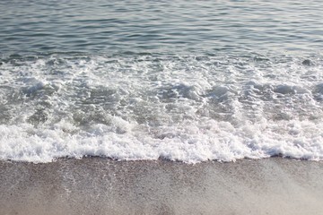 Waves and white sea foam at seashore