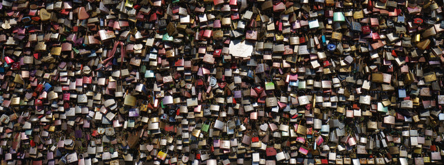 Lovers hang locks on a bridge in city Cologne. Natural bright background. Suitable as bright background, template, poster, banner.