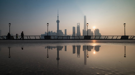 The blur effect of the people are walking in this area. And Shanghai Bund historical buildings old...