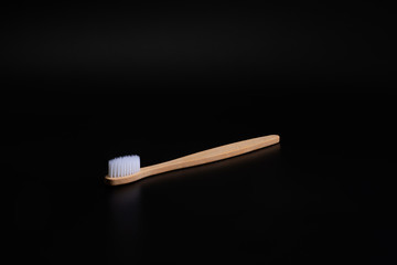 Organic ecological equipment: Wooden Toothbrush on black background