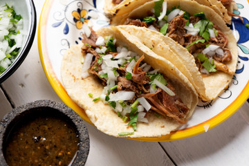 Mexican slow cooked lamb tacos also called barbacoa on white background