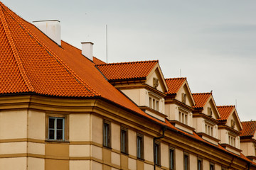 Obraz premium Prague. 05.10.2019: Orange colored roof tops of Prague old town buildings and baroque style houses viewed from top of old town hall tower, Prague, Czech Republic. Panorama.