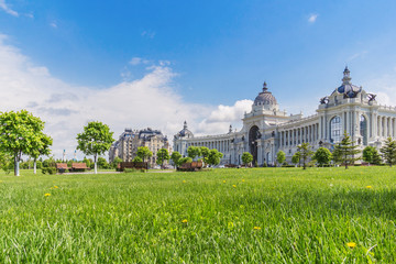 Fototapeta na wymiar View of the Palace of Agriculture through a green lawn in Kazan