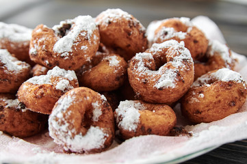 curd rings with topping from powder in a plate on a wooden background
