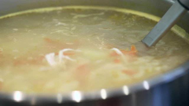 chicken soup with pasta, broth cooks in a pan