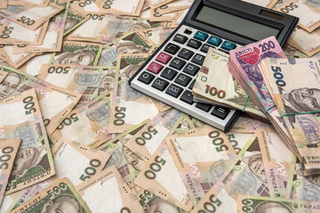 500 hryvnia bills with calculator  as background. Close up. Top view.