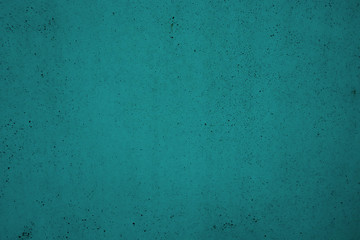 Turquoise background with rare small black dots. The texture of the turquoise surface. Turquoise color for design.