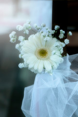 Blurred image of beautiful white Gerbera daisies for decoration on the table for wedding party ceremony.