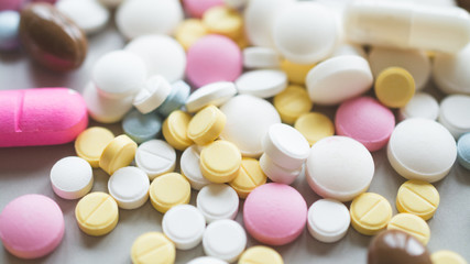 Antidepressant pills of different colors close up