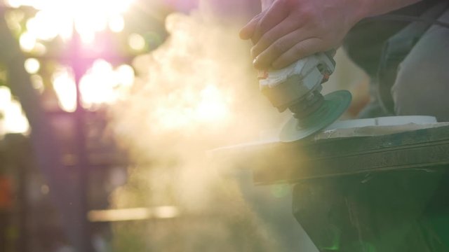 Working with angle grinder, sunset