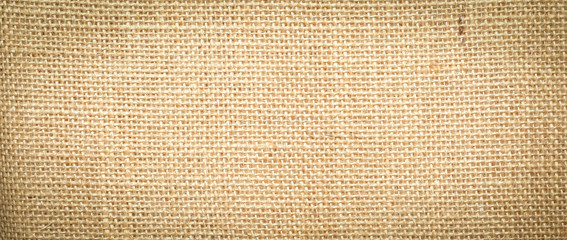 Hessian sackcloth burlap woven texture background  / cotton woven fabric background with flecks of varying colors of beige and brown. with copy space. office desk concept.