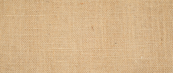 Hessian sackcloth burlap woven texture background  / cotton woven fabric background with flecks of varying colors of beige and brown. with copy space. office desk concept.