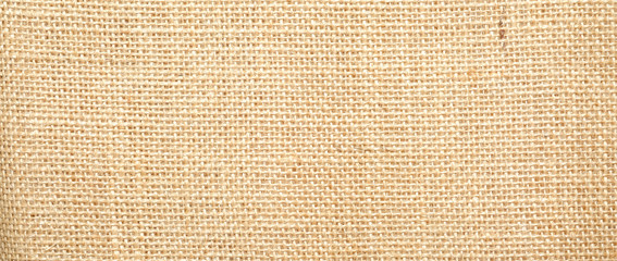 Hessian sackcloth burlap woven texture background  / cotton woven fabric background with flecks of varying colors of beige and brown. with copy space. office desk concept.