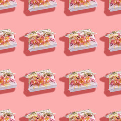 Seamless pattern of gift boxes trendy wrapped in textile in Furoshiki technique with flowers and shadows on pink background. Valentine's day, mother's day, Women's day, Birthday. Zero Waste concept.