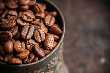 Coffee beans on the rustic wooden background. Selective focus. Shallow depth of field.
