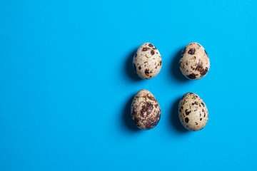 Textured spring background with small quail eggs. Eco products. Horizontal format, top view and copy space food