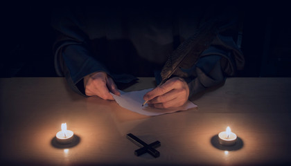 monk or priest writing. religion. hands. spirituallity.