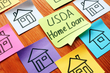 USDA home loan and drawn homes on a paper.