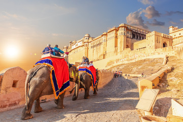 Tourists riding elephants near the famous Amber Fort in Jaipur, India