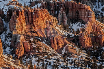 brick-red Bryson canyon at sunset, covered in snow