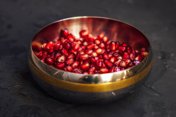 Pomegranate seeds in an iron plate