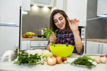 Young woman preparing dinner in a kitchen. healthy lifestyle