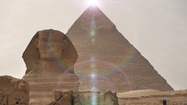 Great Sphinx of Giza and pyramid of Khafre, near Cairo, Egypt. Bright blinking glow over the pyramid of Khafre