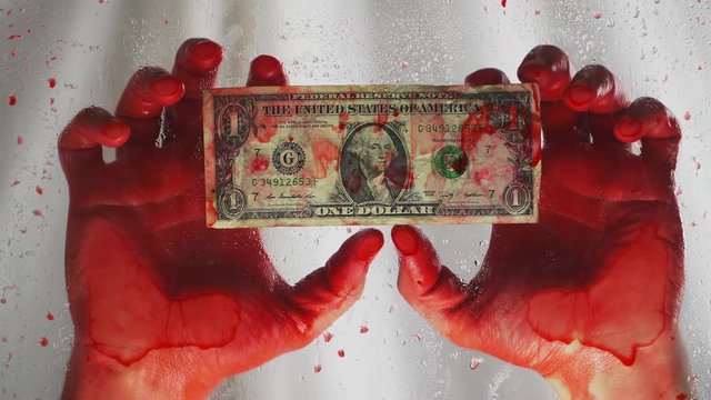 Bloody hands and a dollar bill. Murder for the money. Death due to wealth. Selling human organs. On a white background. Close-up