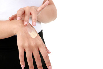 Young women apply nourishing cream to the skin on the back of the hand to be moist, not dry. Concept of beauty and health care