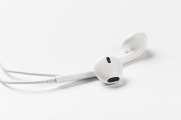White modern headphones with a headset on a light gray background