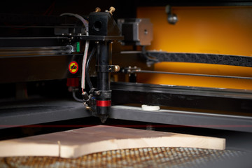 Computer cnc machine and wooden board in workshop