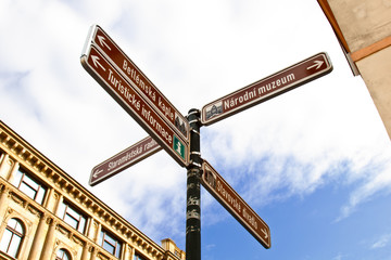 Fototapeta premium Prague. 05.10.2019: A metal signpost with street names in Prague against the background of buildings and the sky.