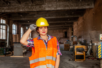 Attractive working woman holding her hard hat