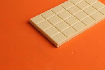 white chocolate tablet in color background