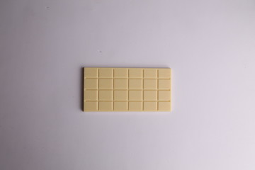 white chocolate tablet in color background