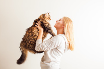 Young woman holding new adopted siberian cat