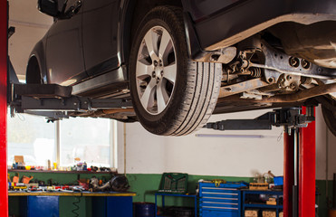 Car undergoing repair or a service in a workshop