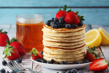 A stack if home-made pancakes with berry